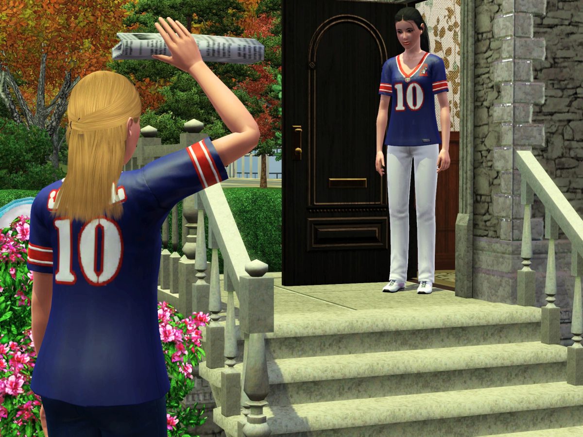 A young blonde woman throws a newspaper towards another woman standing on the steps of a house, both wearing matching jerseys.