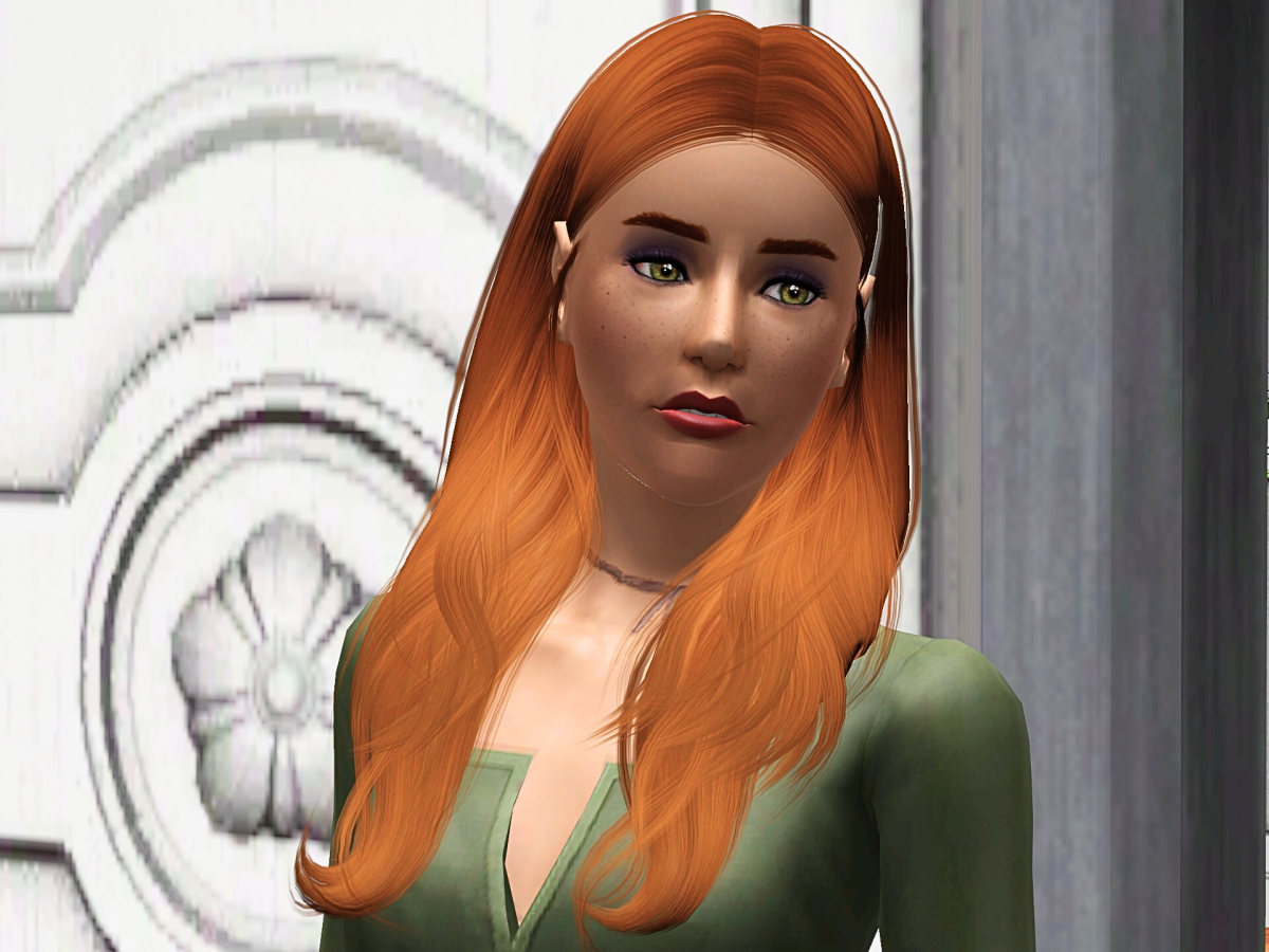 A close-up of a young woman with long, wavy orange hair and striking green eyes, wearing a green garment. She stands in front of an elegantly designed background featuring intricate details.