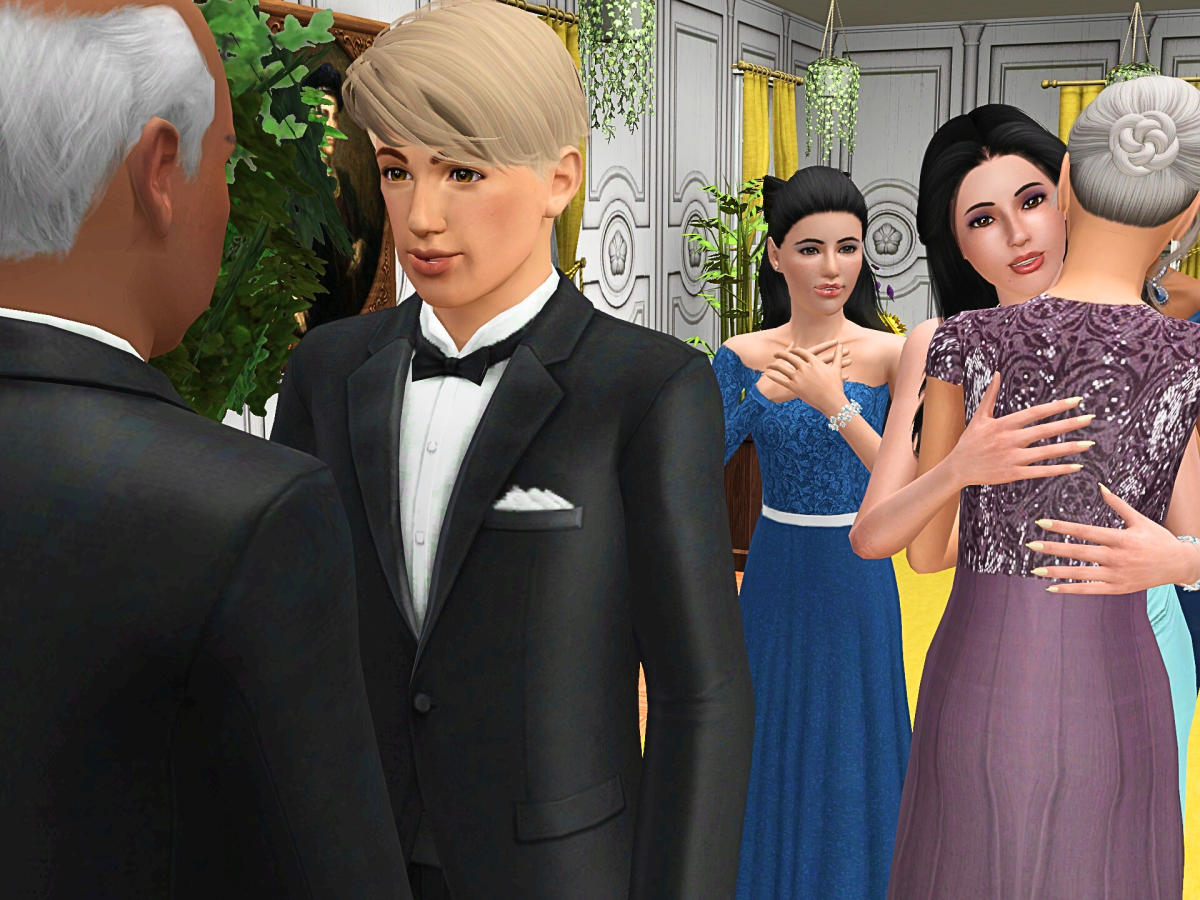 A group of elegantly dressed men and women interacting at a formal event, featuring two men in tuxedos engaging in conversation, while several women in colorful dresses greet and embrace each other in a festive setting.