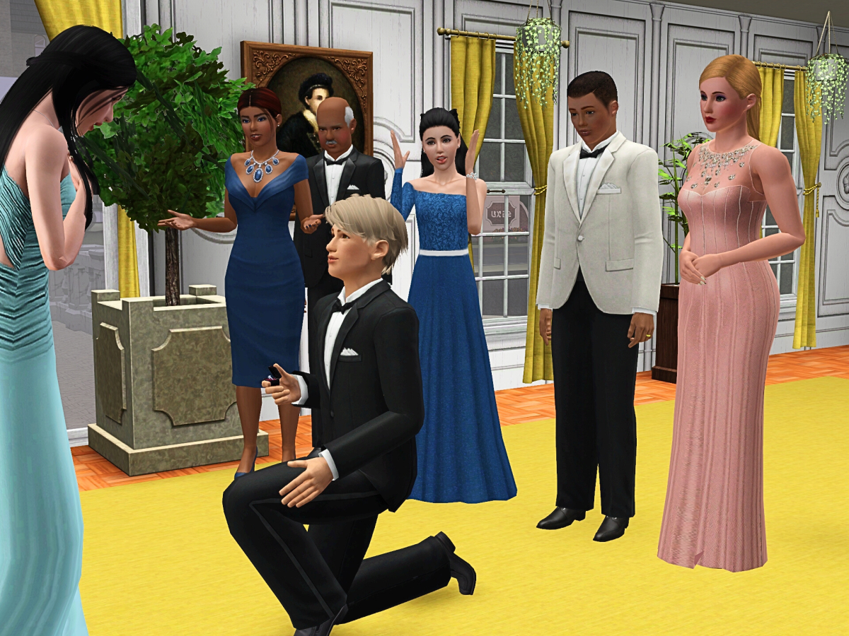 A man in a tuxedo is proposing to a woman in a formal blue dress, while a group of elegantly dressed guests watch with expressions of surprise and joy in a decorated room.