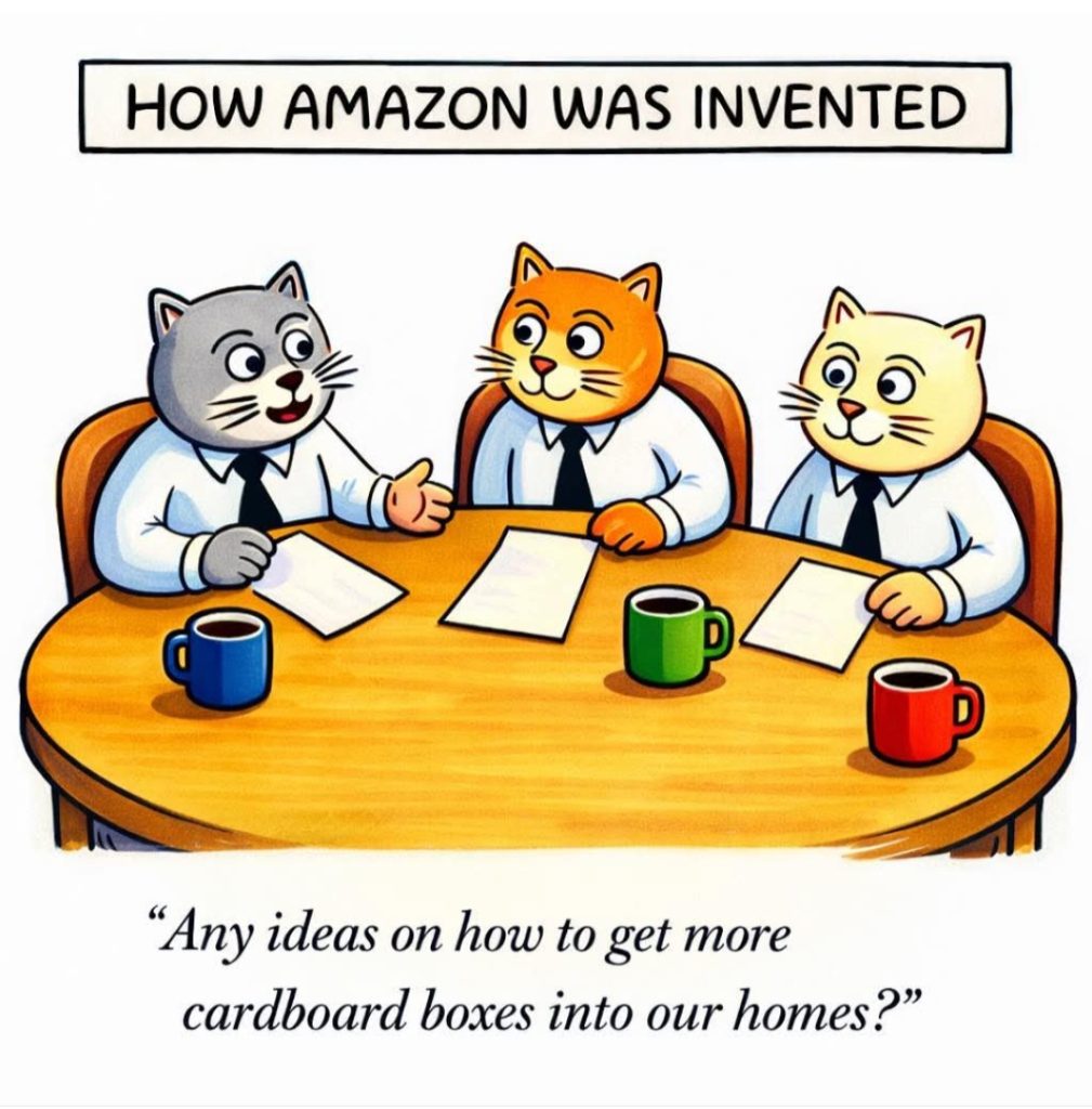 Cartoon depicting three cats in business attire sitting around a table with papers and coffee cups, discussing ideas humorously centered on acquiring more cardboard boxes.
