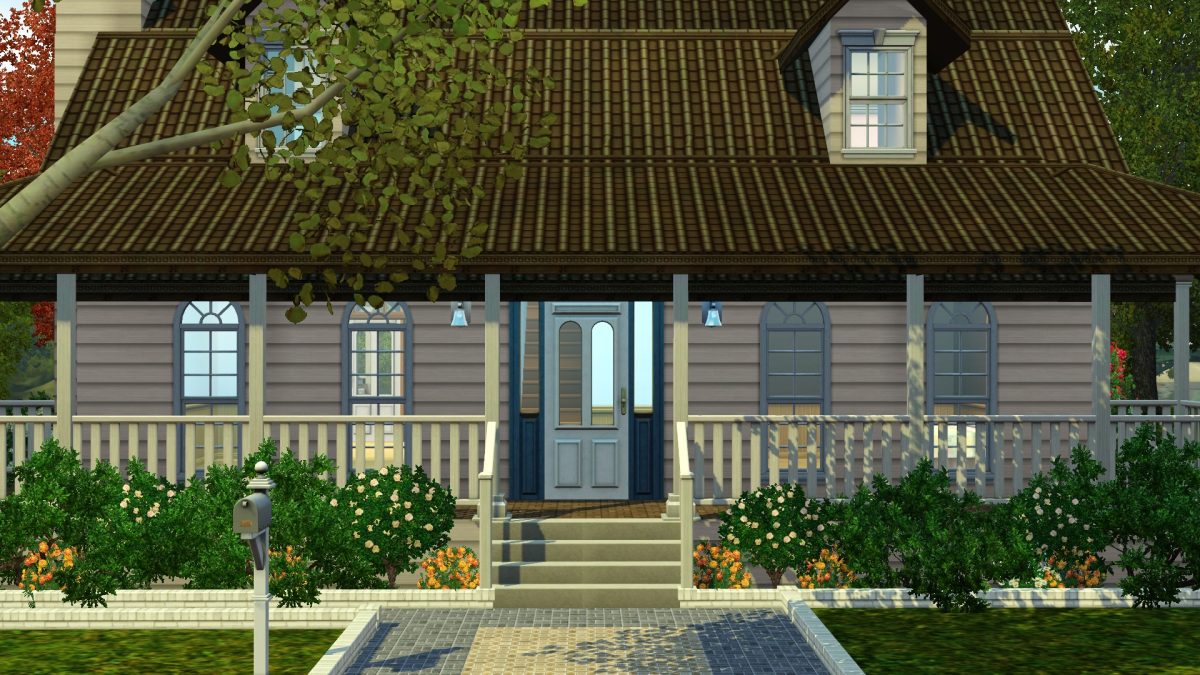 A charming house with a brown shingled roof, light-colored walls, and a front porch surrounded by greenery and flowers.